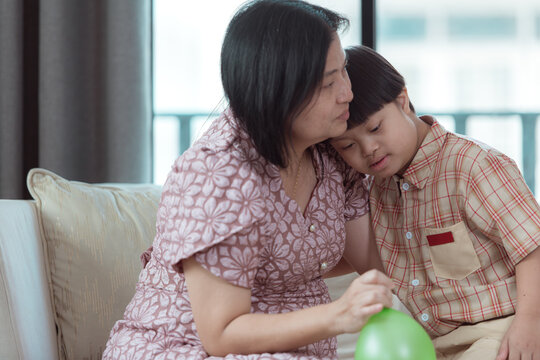 A special child and his mom having fun and relaxing on a holiday together in the living room of the house - Powered by Adobe