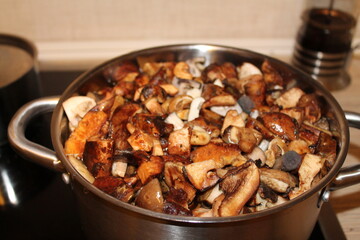 Chopped mushrooms are boiled in a large saucepan. High quality photo