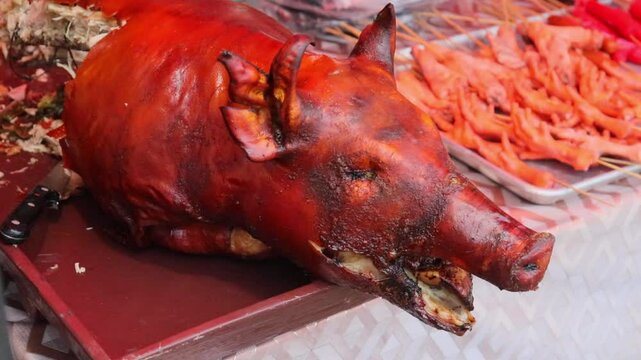 lechon pig, fire roasted whole pig at marketplace restaurant outdoor eatery