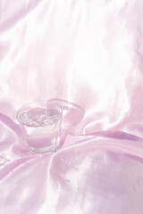 Minimalist Still Life with Water Glass and Satin Background