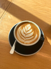 Coffee cup holding cappuccino in a cafe - user generated content UGC