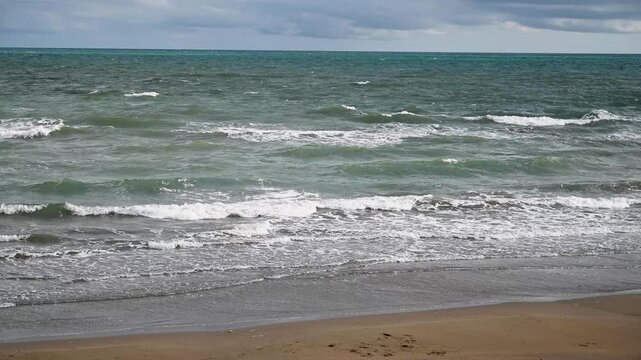 Tyrrhenian Sea in Anzio, Italy. Waves on the sea. Cloudy weather. 