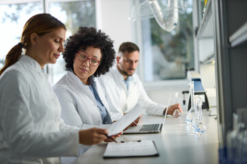 Fototapeta premium Medical experts talking while working on medical research in laboratory.