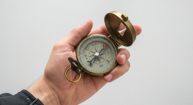 Close-up of hand holding vintage compass - Powered by Adobe