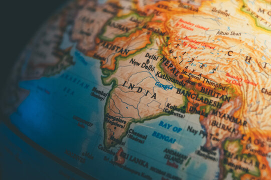 India on the world globe - a close up shot of the Indian Subcontinent and the surrounding countries as seen on a vintage globe \ map