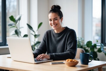 Fototapeta premium Cheerful Young Woman Working Remotely in a Cozy Home Office with Laptop