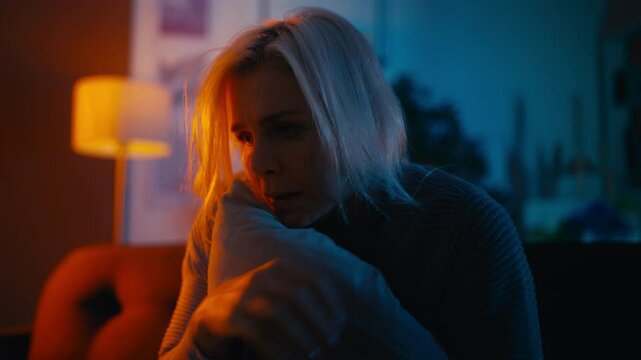 Shocked sad woman drinking liquor from a bottle, suffering anxiety, restlessness