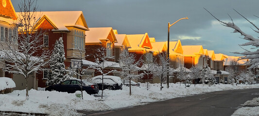 Morning sun shining on the snow-covered roofs