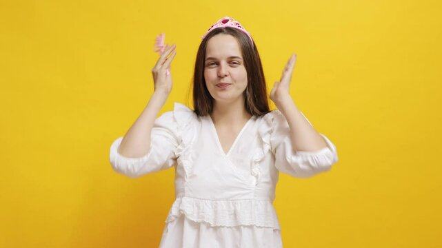 Celebrating a birthday with a tiara, balloons, and cheerful decorations on a yellow background