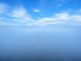 Obraz premium A beautiful bright blue misty morning sky with wavy clouds that resemble elegant ripples on a pond, wavy clouds, cloud formations, atmospheric effects