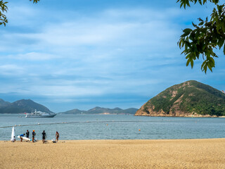 Obraz premium Repulse bay beach landscape view in Hong Kong, under cloudy blue sky in summer, with some unrecognized people