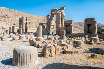 Obraz premium Persepolis, beautiful stone archway stands tall with a blue sky, Iran