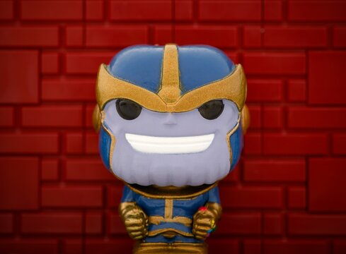 Tambov, Russian Federation - August 23, 2024 Thanos Funko POP Mini Vinyl Figure against a red brick wall background.