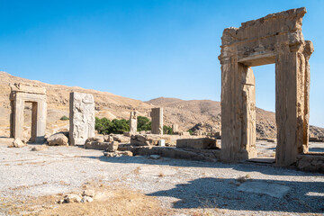 Obraz premium Persepolis, beautiful stone archway stands tall with a blue sky, Iran