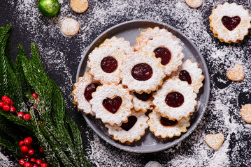 Traditional Christmas Linzer Cookies on a Christmas rustic background