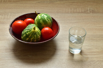 Vegetable food in red dish glass of water