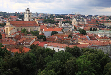 Fototapeta premium Panoramic aerial view of the historical part of the city of Vilnius (Lithuania) with numerous churches on the background of a stormy sky