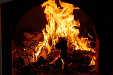 A fire is burning in a wood burning oven