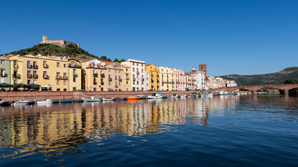 Panoramic view of the picturesque town of Bosa with its colorful houses reflected in the Temo River, Sardinia, Italy