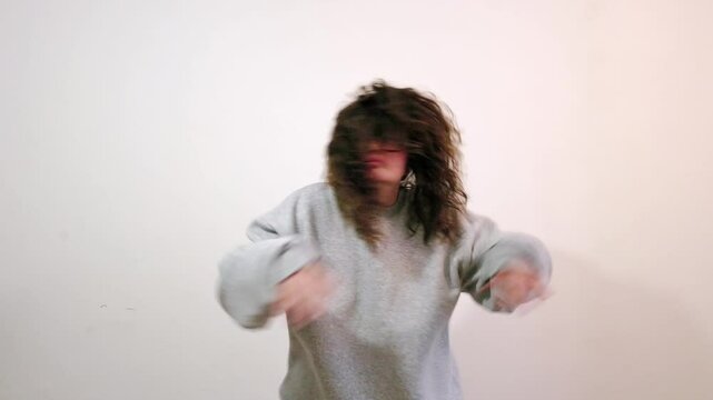 Dance, happy and face of a woman at a party isolated on a dark background in a studio. Freedom, smile and portrait of a young dancing girl moving for celebration, excited and happiness at a disco