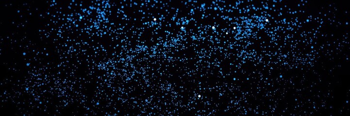 Fototapeta premium Dazzling blue specks scattered across a velvety black surface, glittering dust, sparkly background