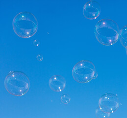 A blue sky with many bubbles floating in it