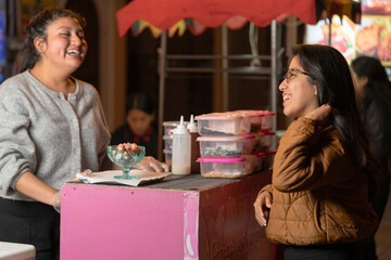 Street vendor serving dessert to customer at night market