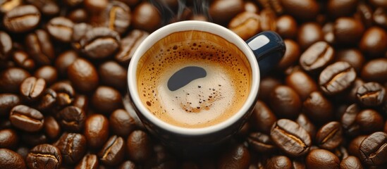 Close up of a steaming coffee cup surrounded by fresh roasted coffee beans perfect for coffee enthusiasts