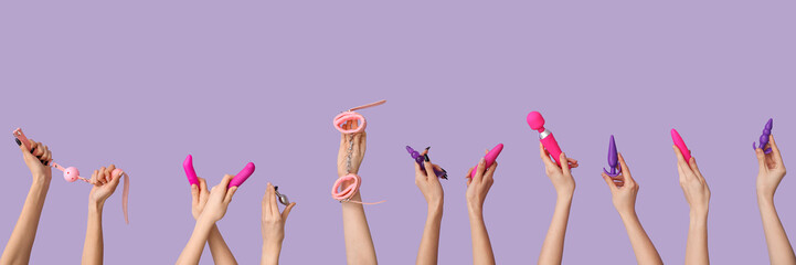 Women with vibrator and anal plugs on lilac background