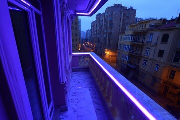 Obraz premium a balcony with purple lights on it