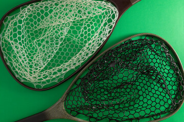 Modern fishing landing net with silicone mesh in black and white.