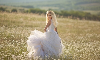 beautiful girl, a blonde in a vintage white dress walks in a blooming apple orchard, a bouquet of anemones, a bride