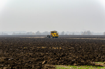 The tractor plows the land in autumn, for sowing. Image of agriculture