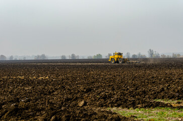 The tractor plows the land in autumn, for sowing. Image of agriculture