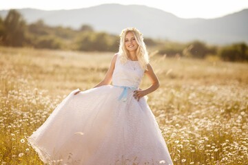 beautiful girl, a blonde in a vintage white dress walks in a blooming apple orchard, a bouquet of anemones, a bride