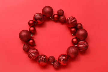 Frame made of Christmas tree balls on red background
