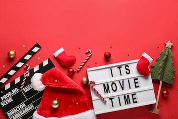 Movie clapper with text ITS MOVIE TIME and Christmas decor on red background