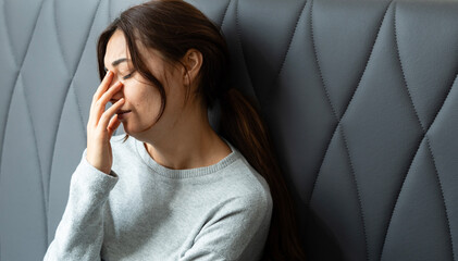 Unhappy lonely depressed woman is sitting on the bedroom, depression concept