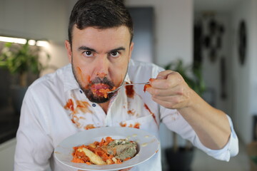 Messy man eating a plate with anxiety 