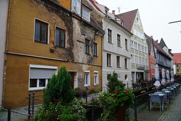 Colorful buildings on the sides of the small stream Memminger Ach and pedestrian bridges in the historic old town of Memmingen, Bavaria, Germany.