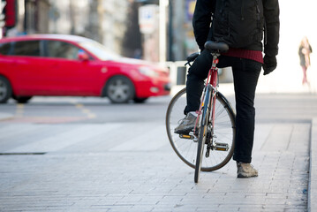 Bicyclist on the street lets traffic through © Yury Kirillov