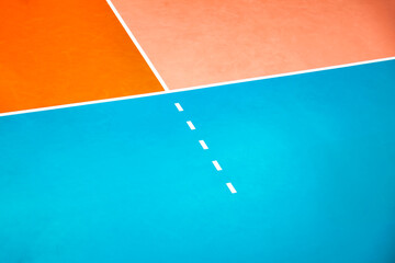 Fototapeta premium Cropped photo of orange volleyball court with white lines, no one. Professional volleyball courts in sport gym, sporty backdrop. Team game success, healthy sporty lifestyle concept. Copy ad text space