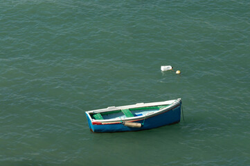 Fototapeta premium Empty fishing boat in the sea on a sunny day, closeup of photo.