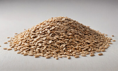 Obraz premium A pile of oat groats sits on a white surface