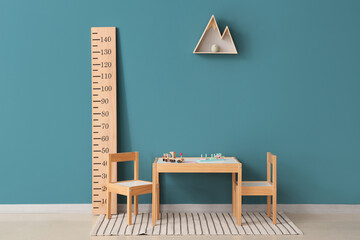 Interior of children's room with table, chairs and stadiometer