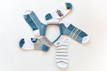 A set of colorful adult socks on a white background. contrasting socks in close-up. socks in a row