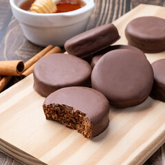 Brazilian Pao de Mel or chocolate covered honey cookies over a wooden table