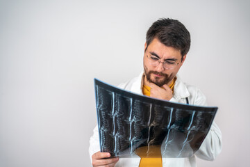 Medical Doctor Reviewing MRI Image of Spine, Healthcare Professional Analyzing Spinal Scan for...