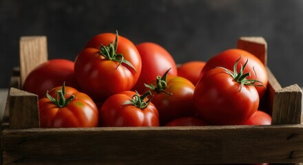 Fresh ripe tomatoes in wooden crate on dark background