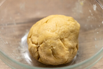 Dough pastry made from flour, eggs and butter in a bowl prepared to make a quiche